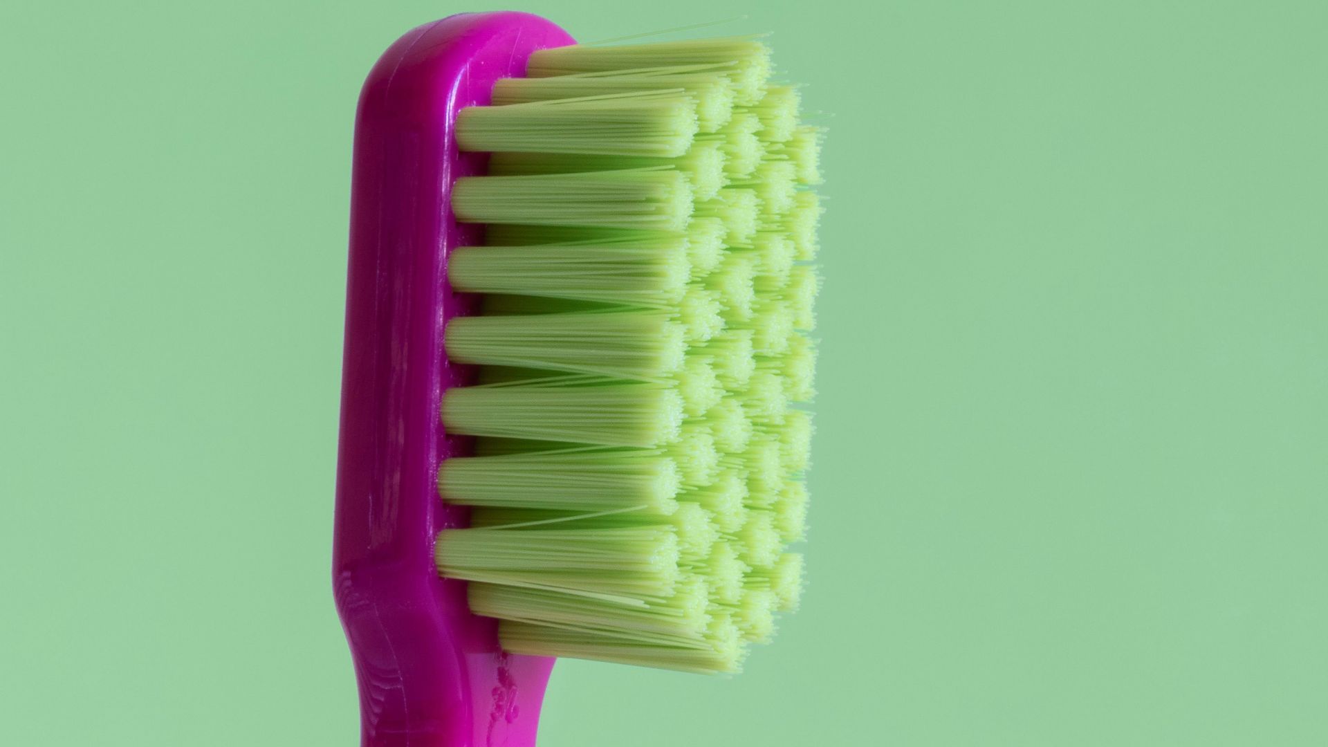 purple and green toothbrush