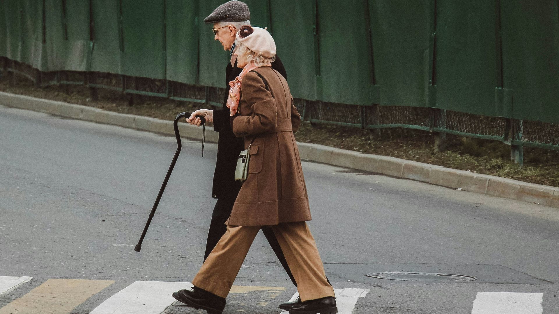 man and woman walking on pedestrian line during daytime