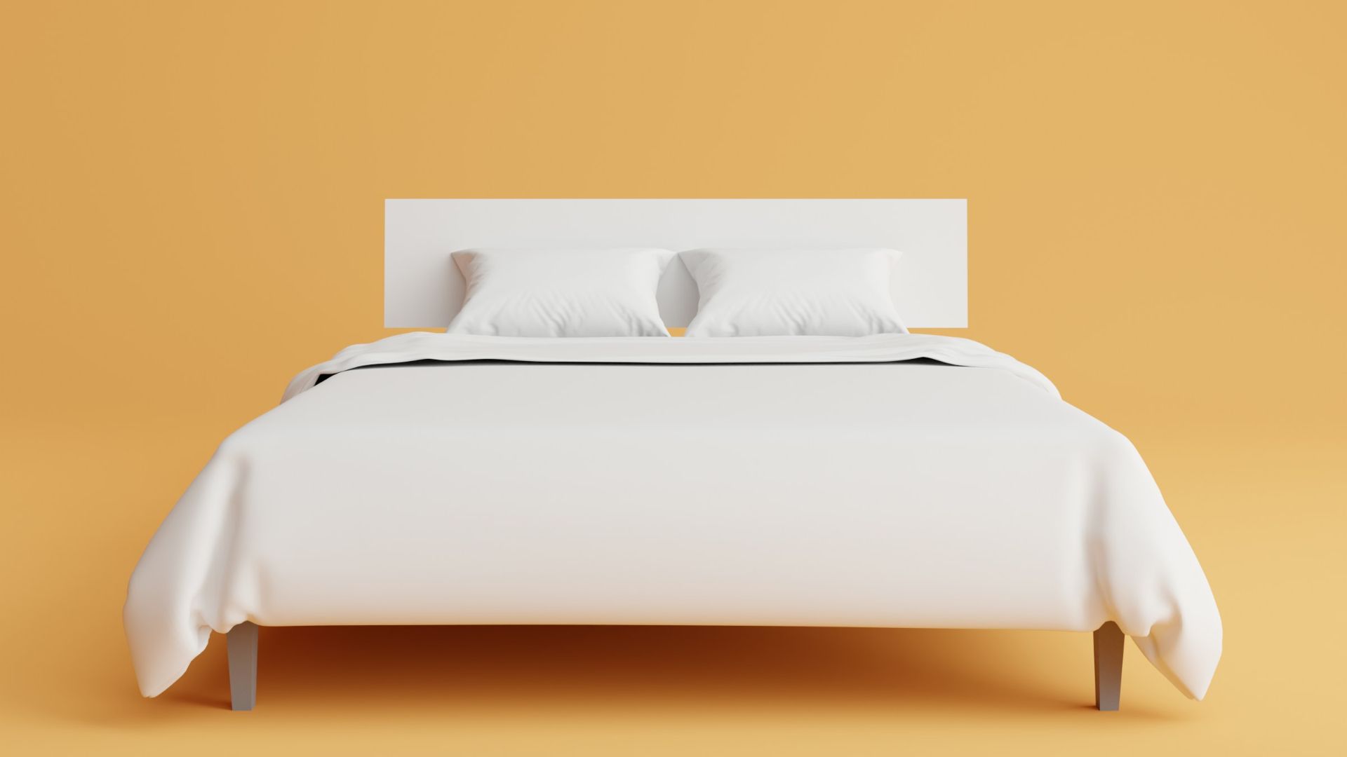a bed with a white cover and pillows on top of it