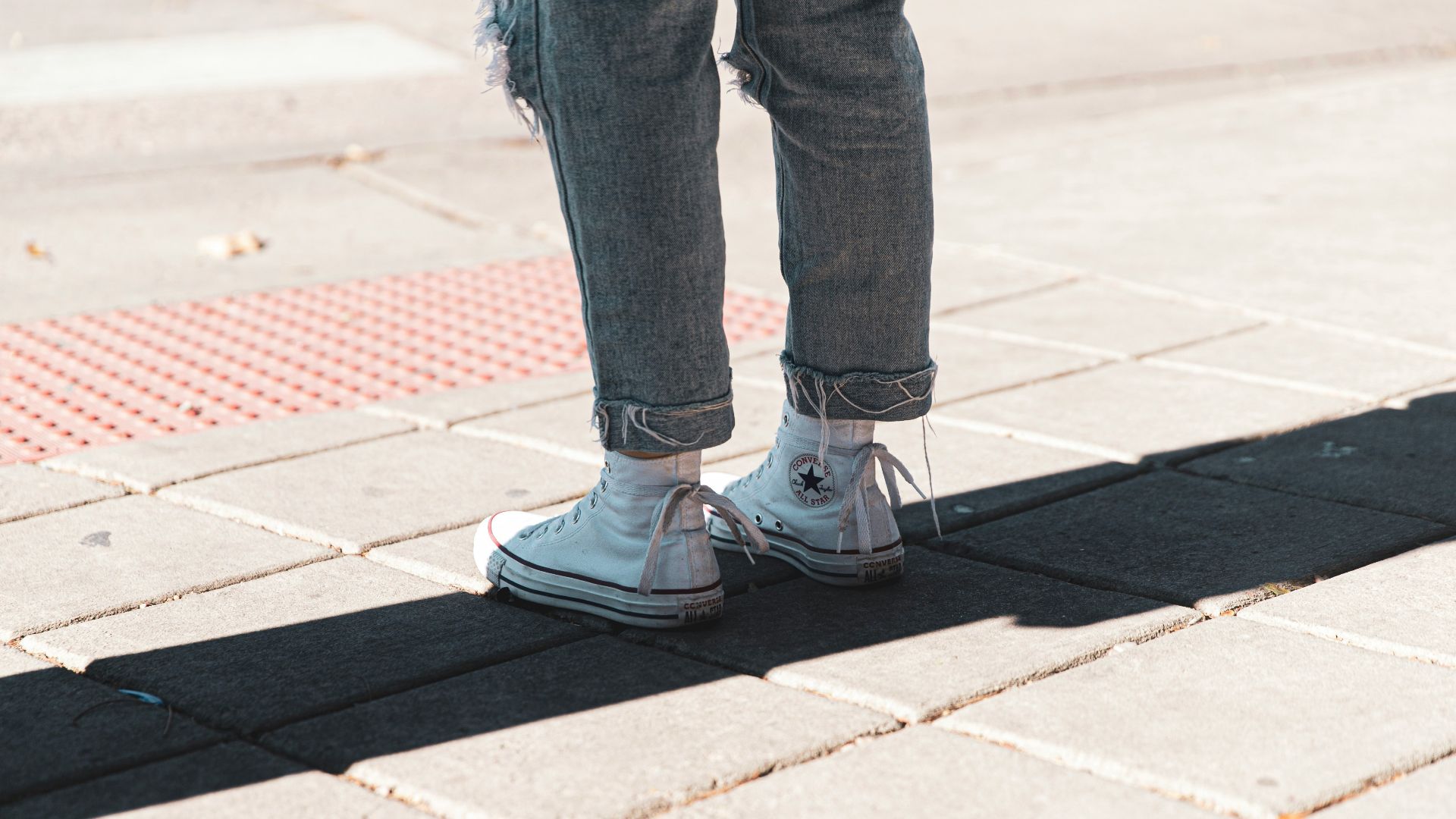 person standing on brick pathway