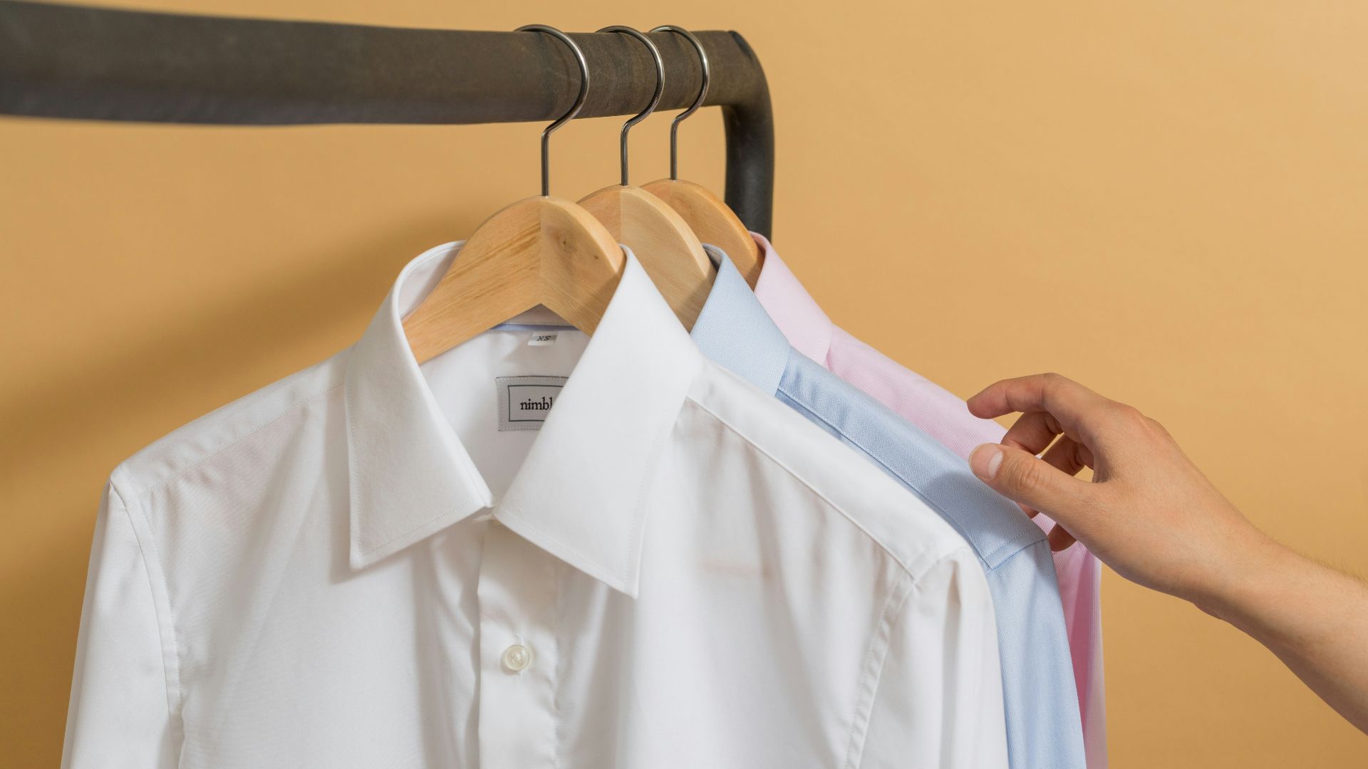 white button up shirt on black clothes hanger