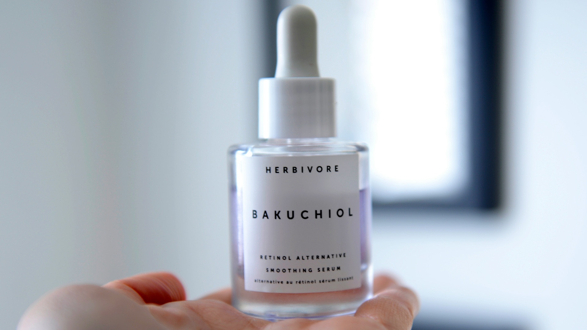 person holding white plastic bottle