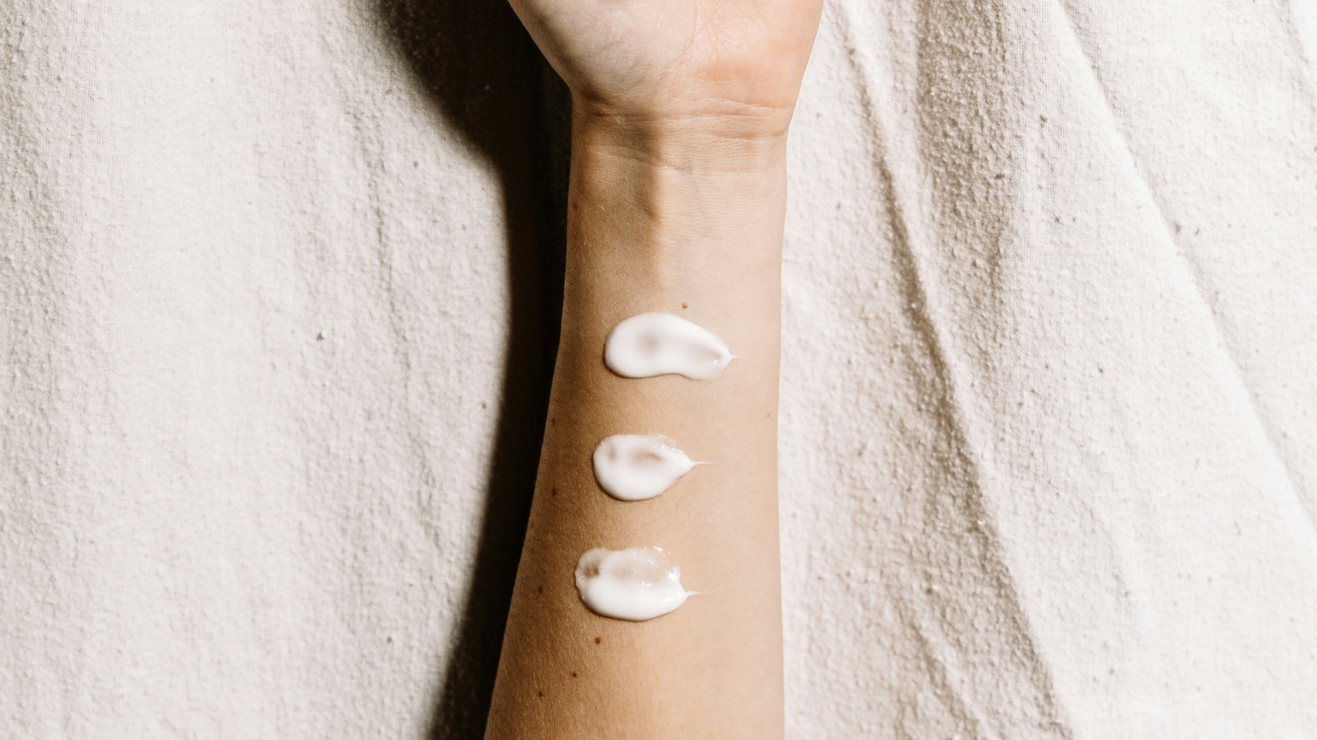 person with black and white hearts tattoo on right hand