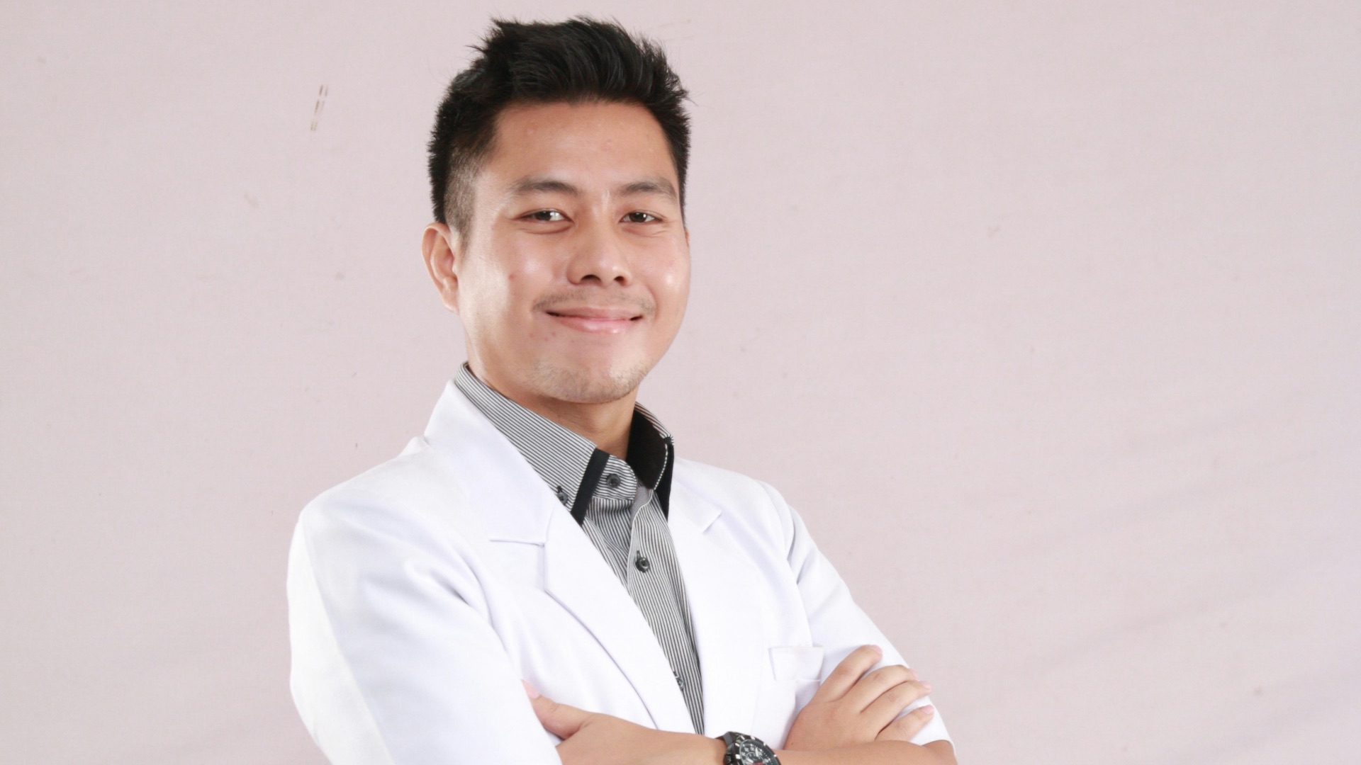 a man in a white shirt and tie posing for a picture