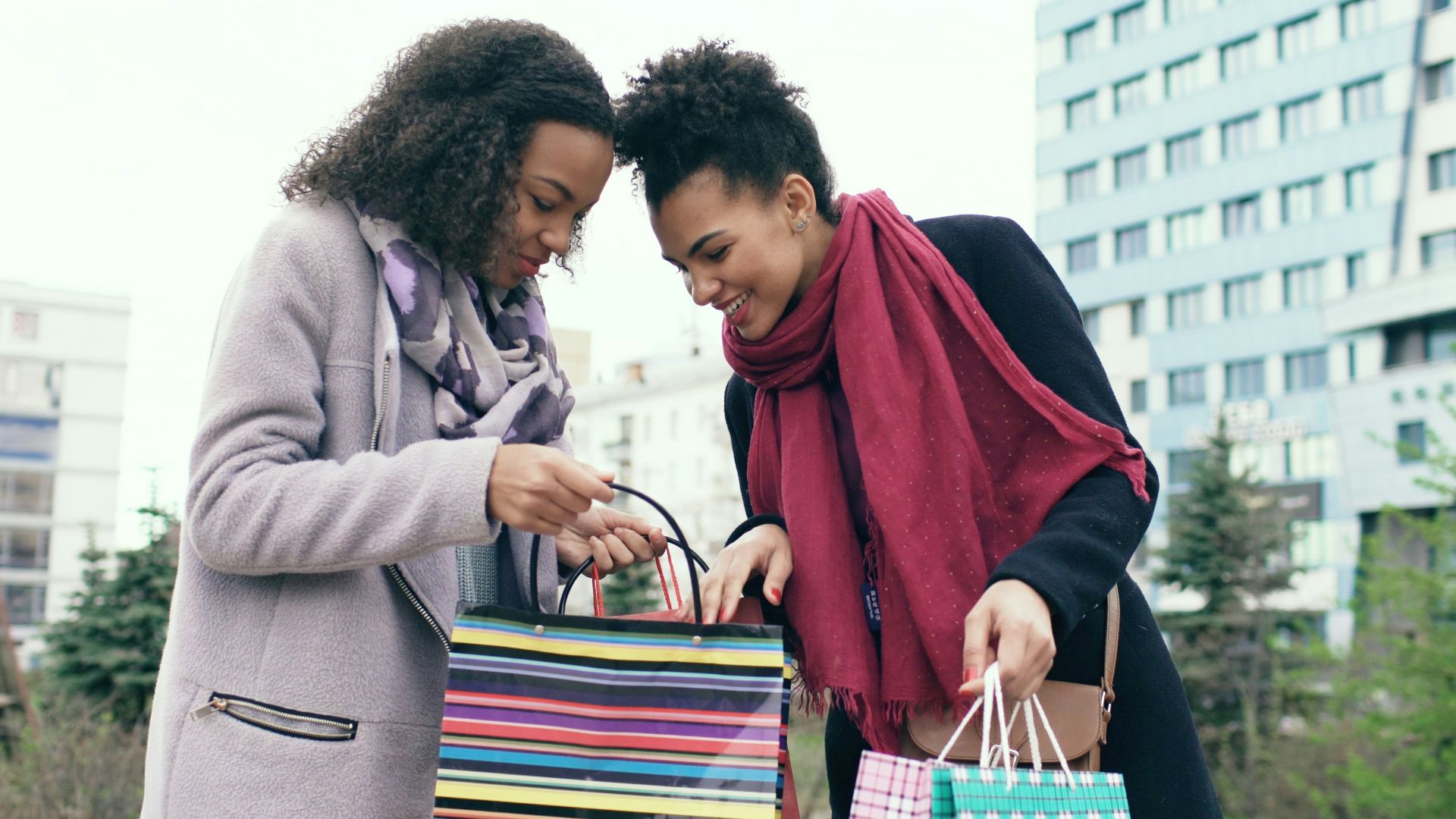 Two women looking into shopping bags