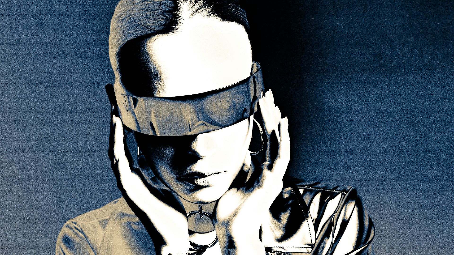 Woman in futuristic goggles and metallic jacket