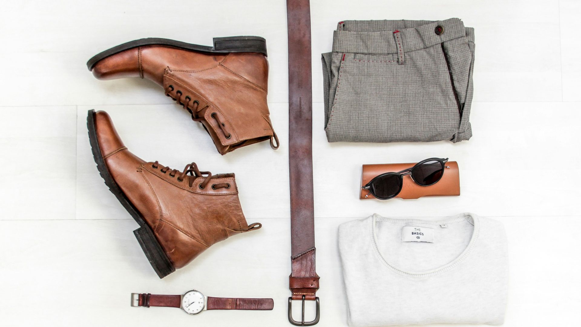 pair of brown leather boots beside bet