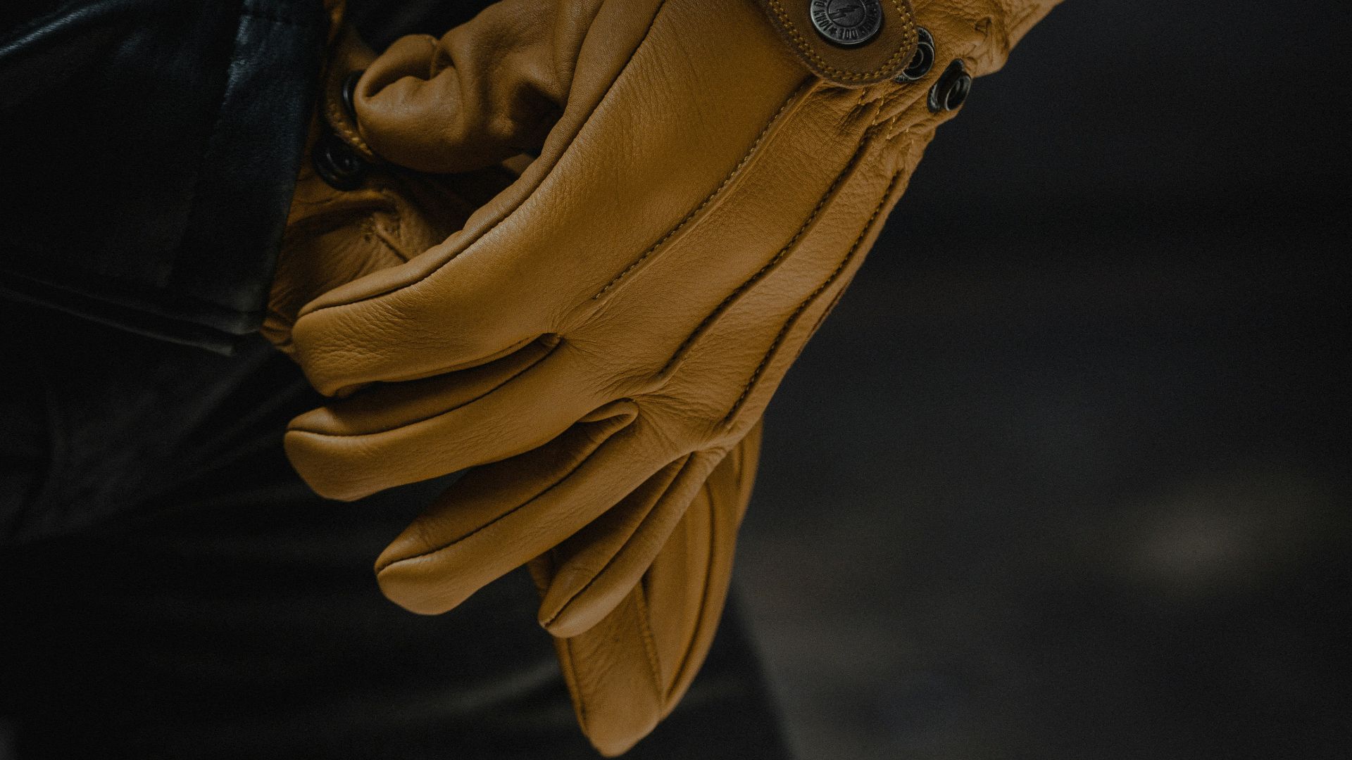 person wearing black leather gloves