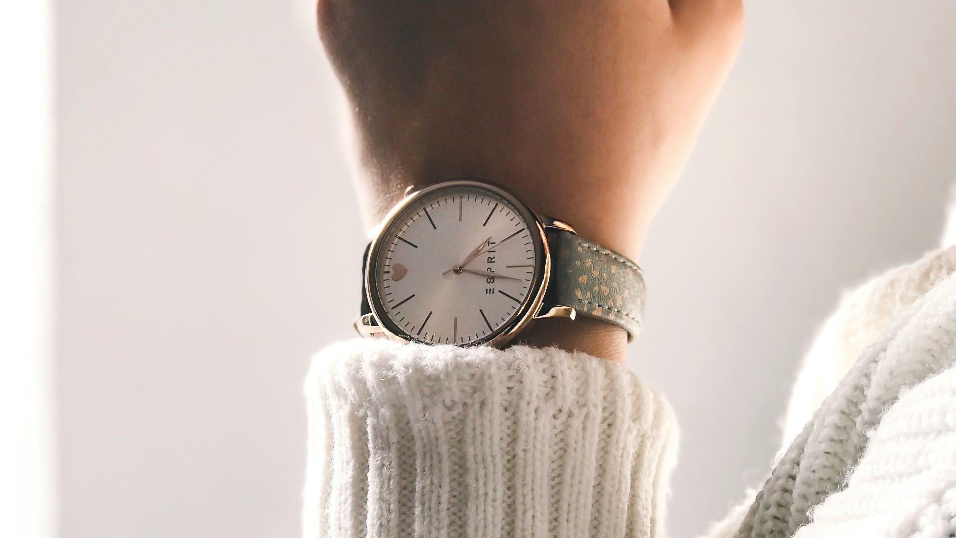 person wearing round silver-colored analog watch