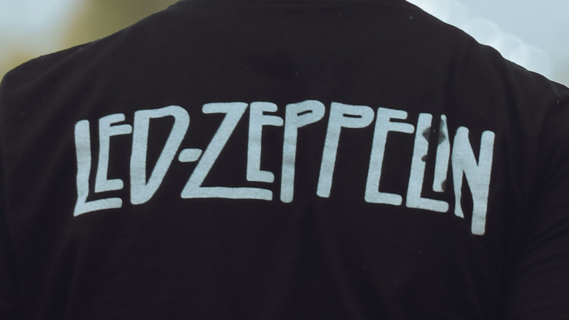 a man in a black shirt is holding a frisbee