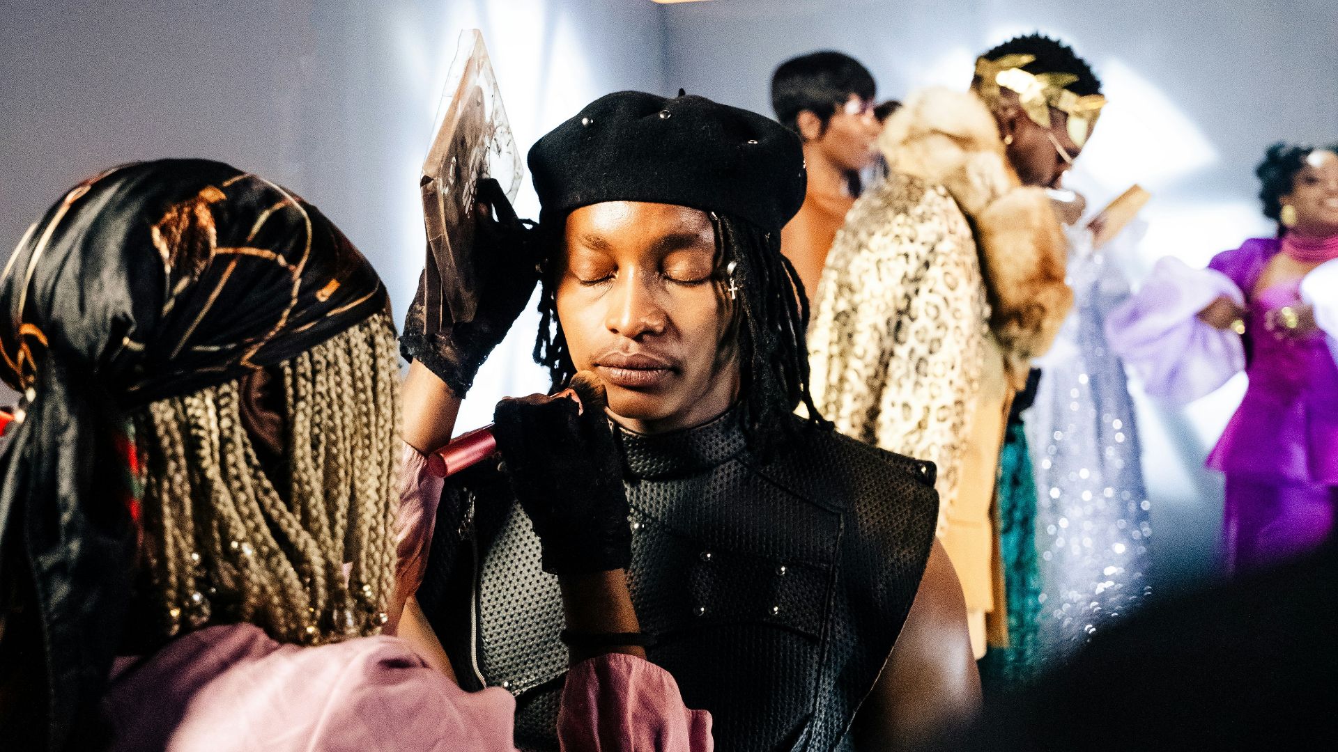 Models preparing backstage before a fashion show.