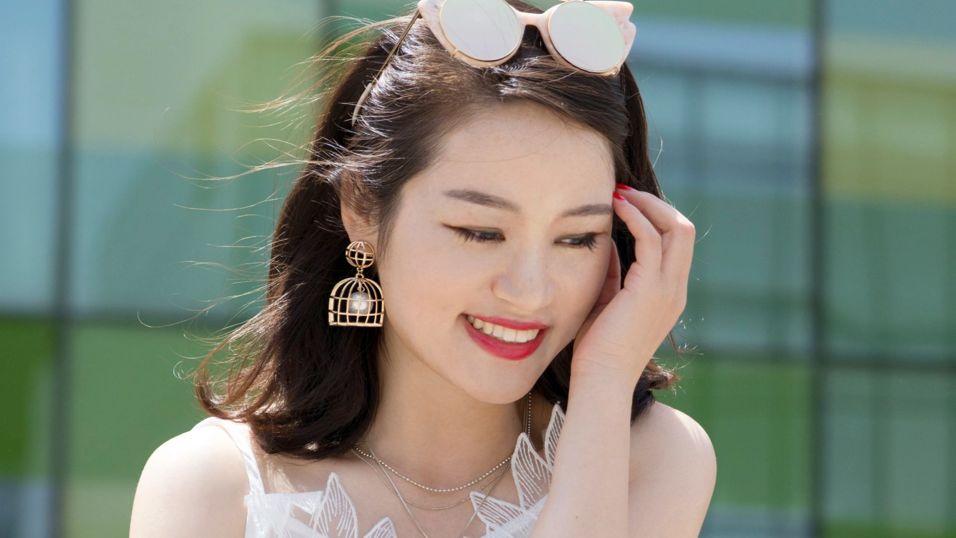 woman holding her head while sitting on table