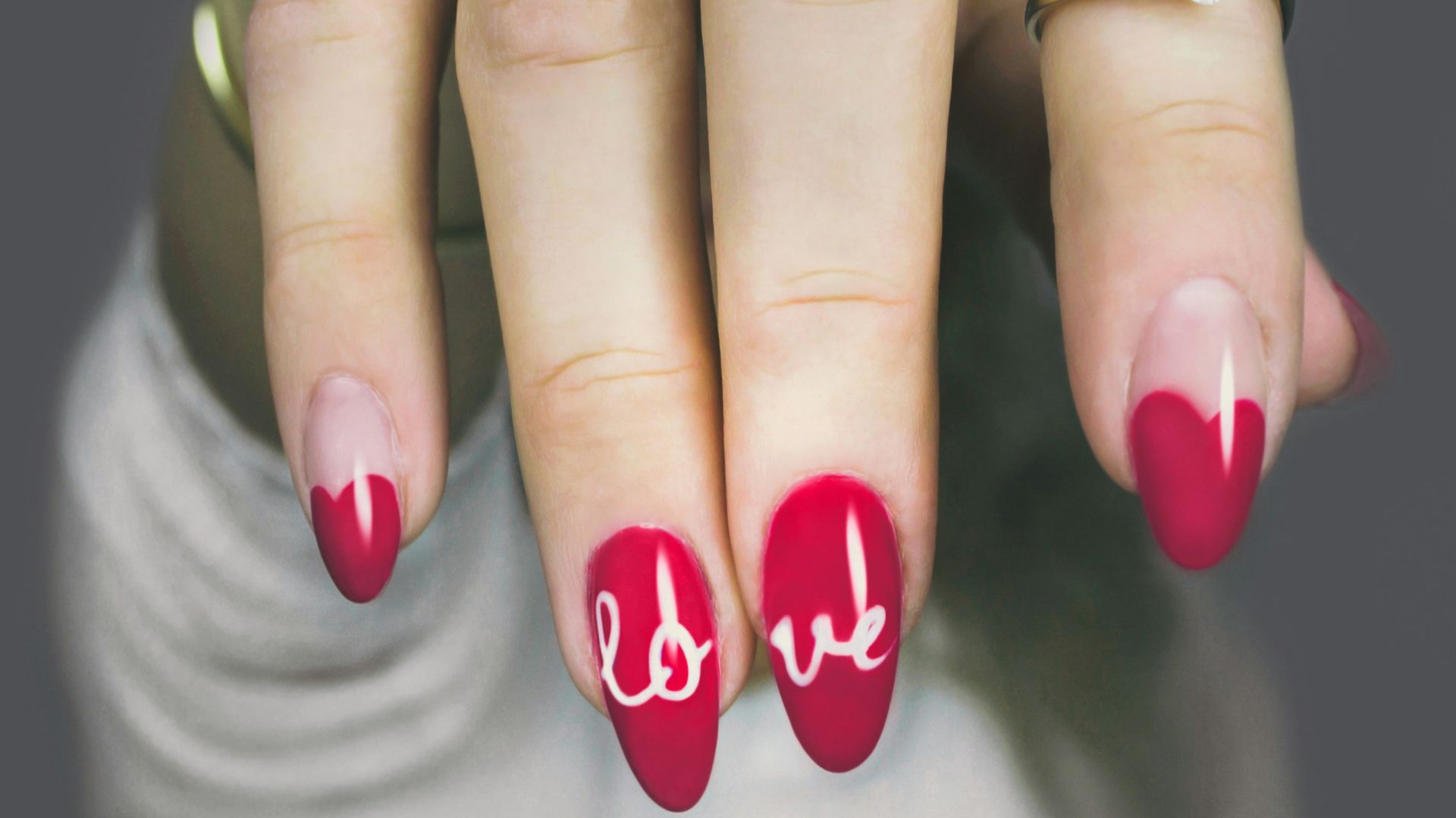 selective focus photography of woman's pink manicure