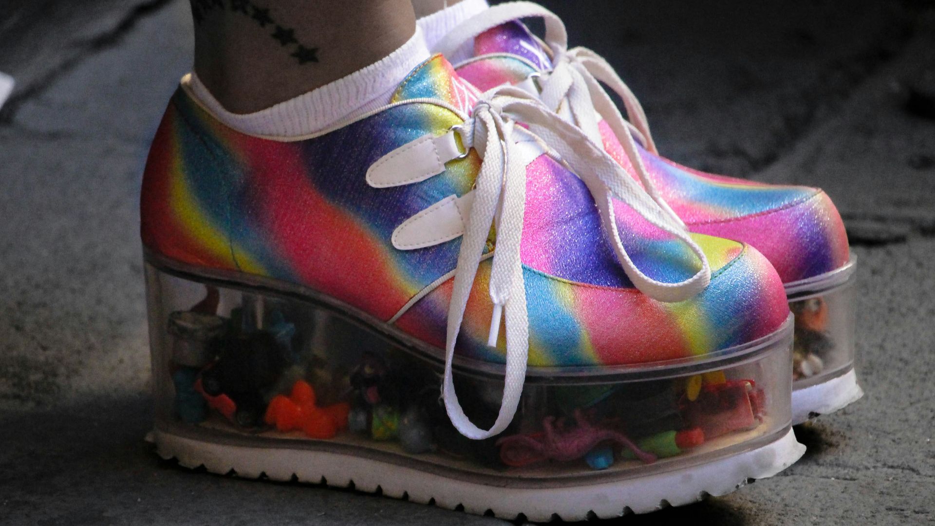 person wearing multicolored wedge shoes