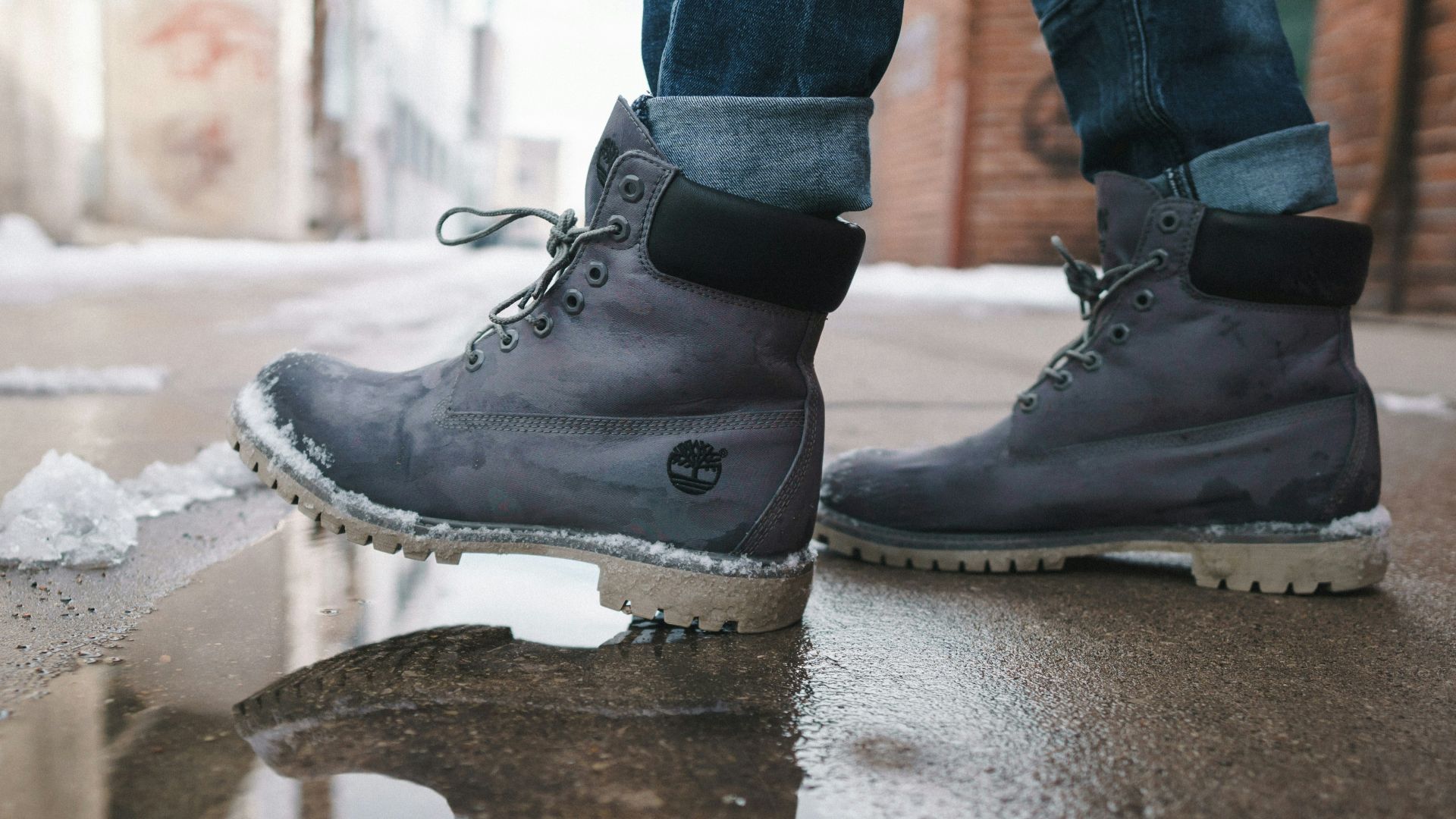 person wearing pair of gray Timberland work boots