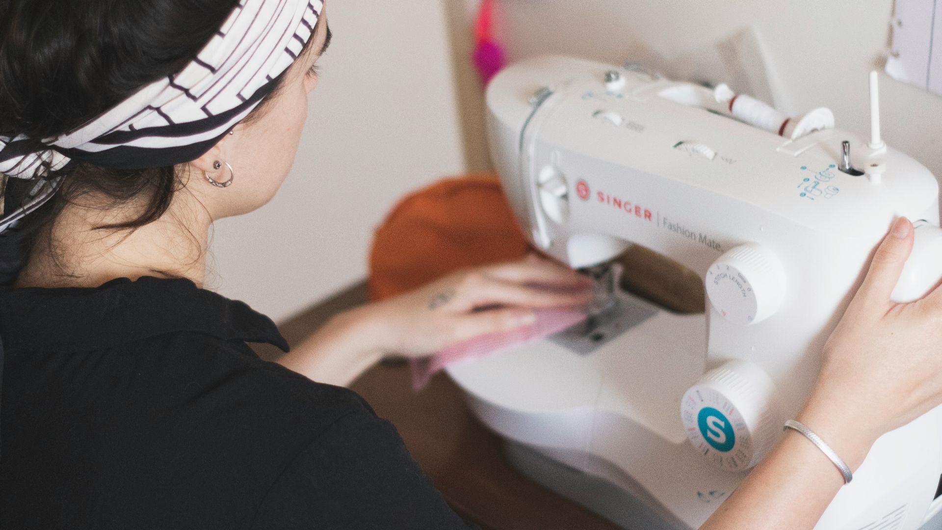 woman in black long sleeve shirt sewing