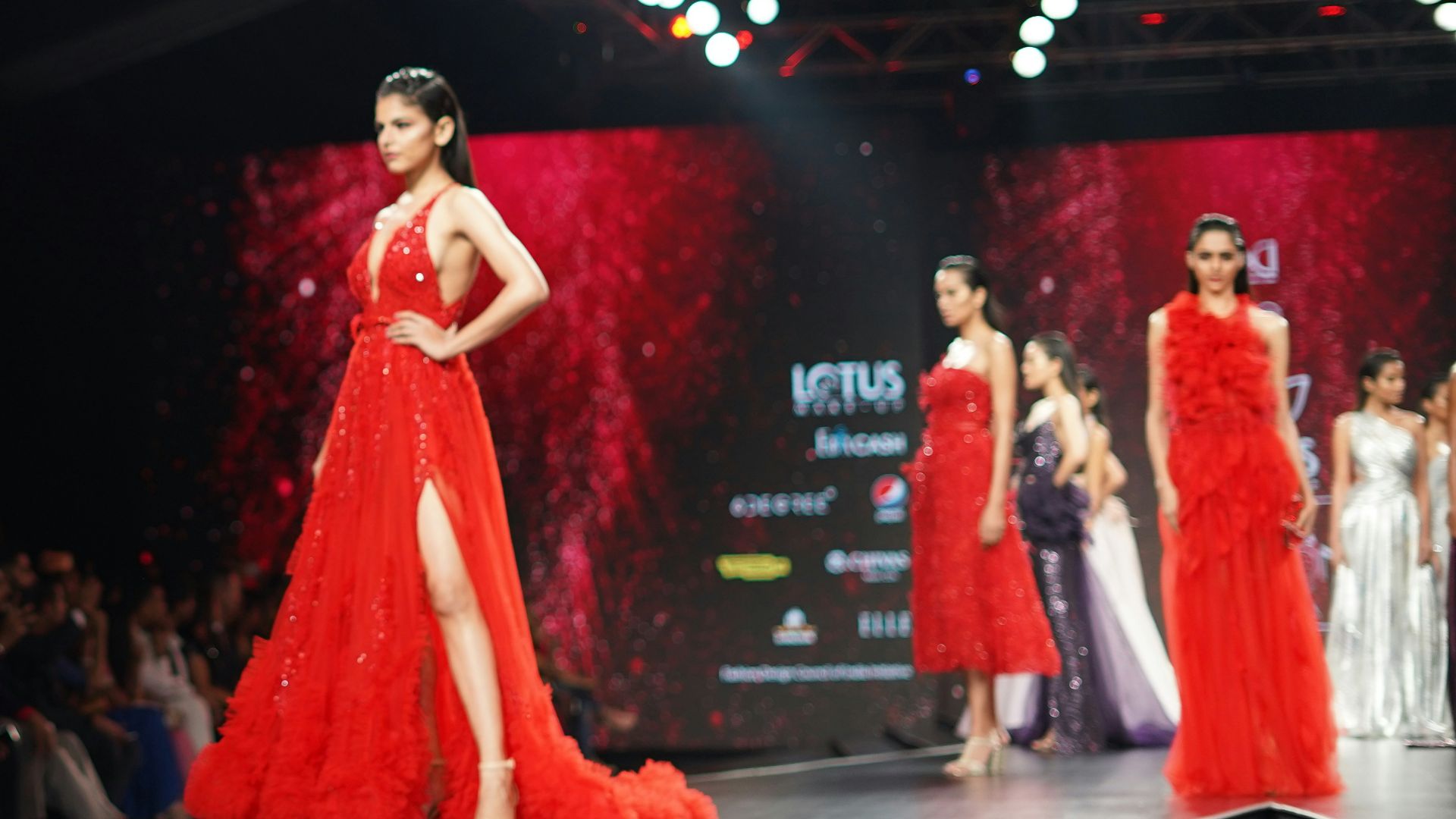 woman wearing maroon one-shoulder slit-side dress