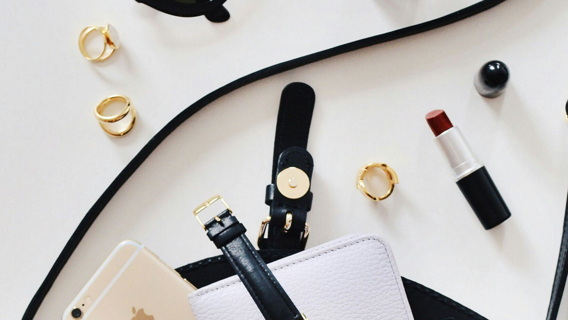 women's sunglasses and black bag with watch and iPhone 6