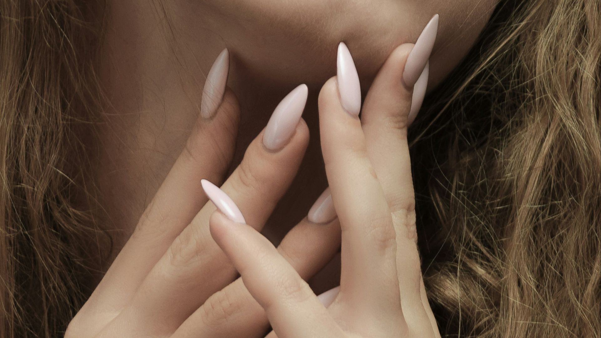 a woman with long hair and white nails posing for a picture