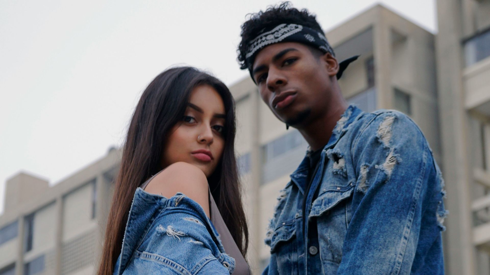 couple wearing distress denim jackets