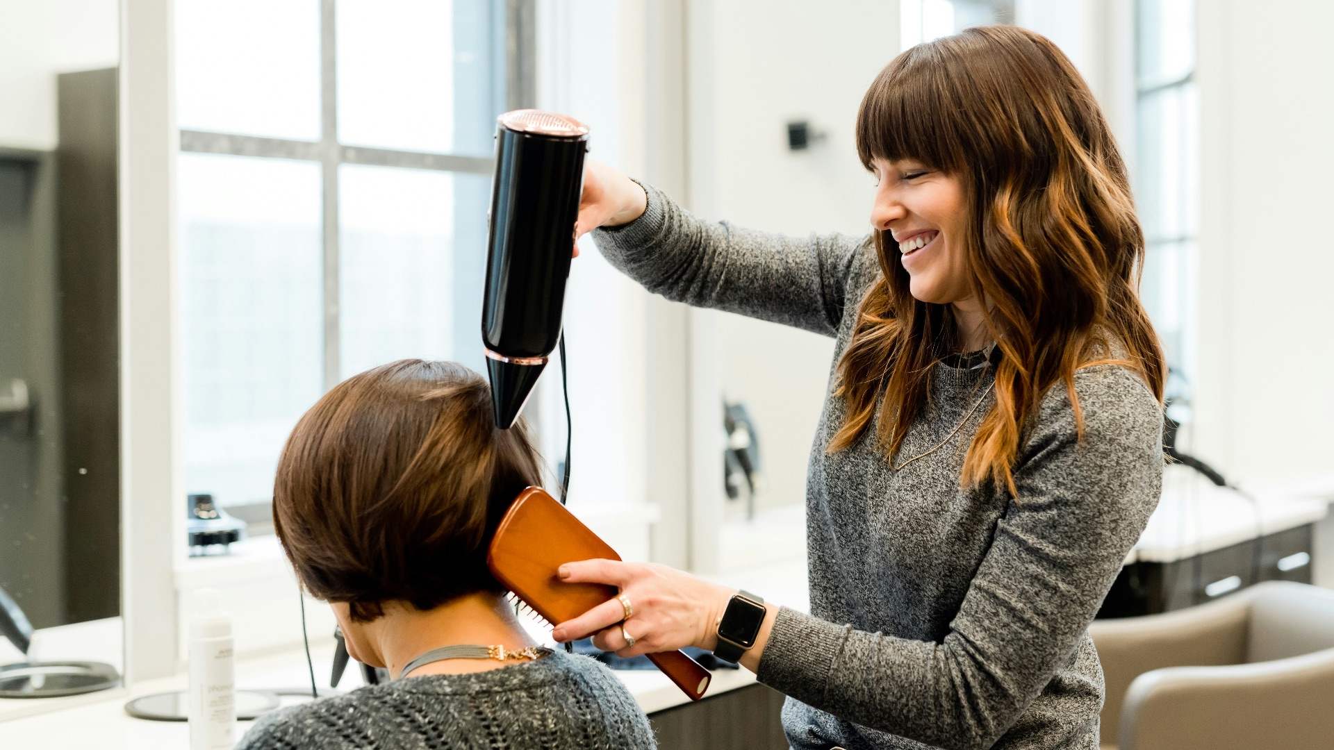 woman holding hair dryer