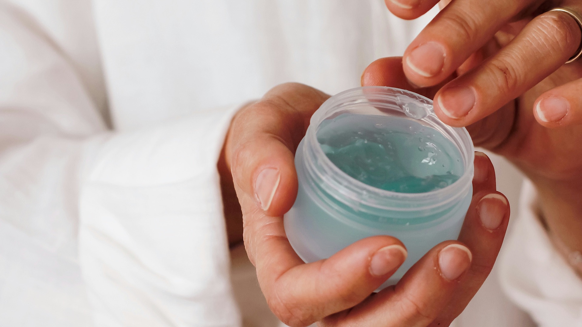 person holding blue plastic container