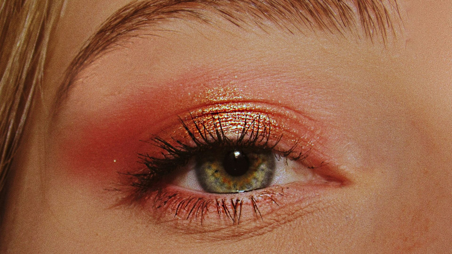 woman with pink and gold eyeshadow makeup
