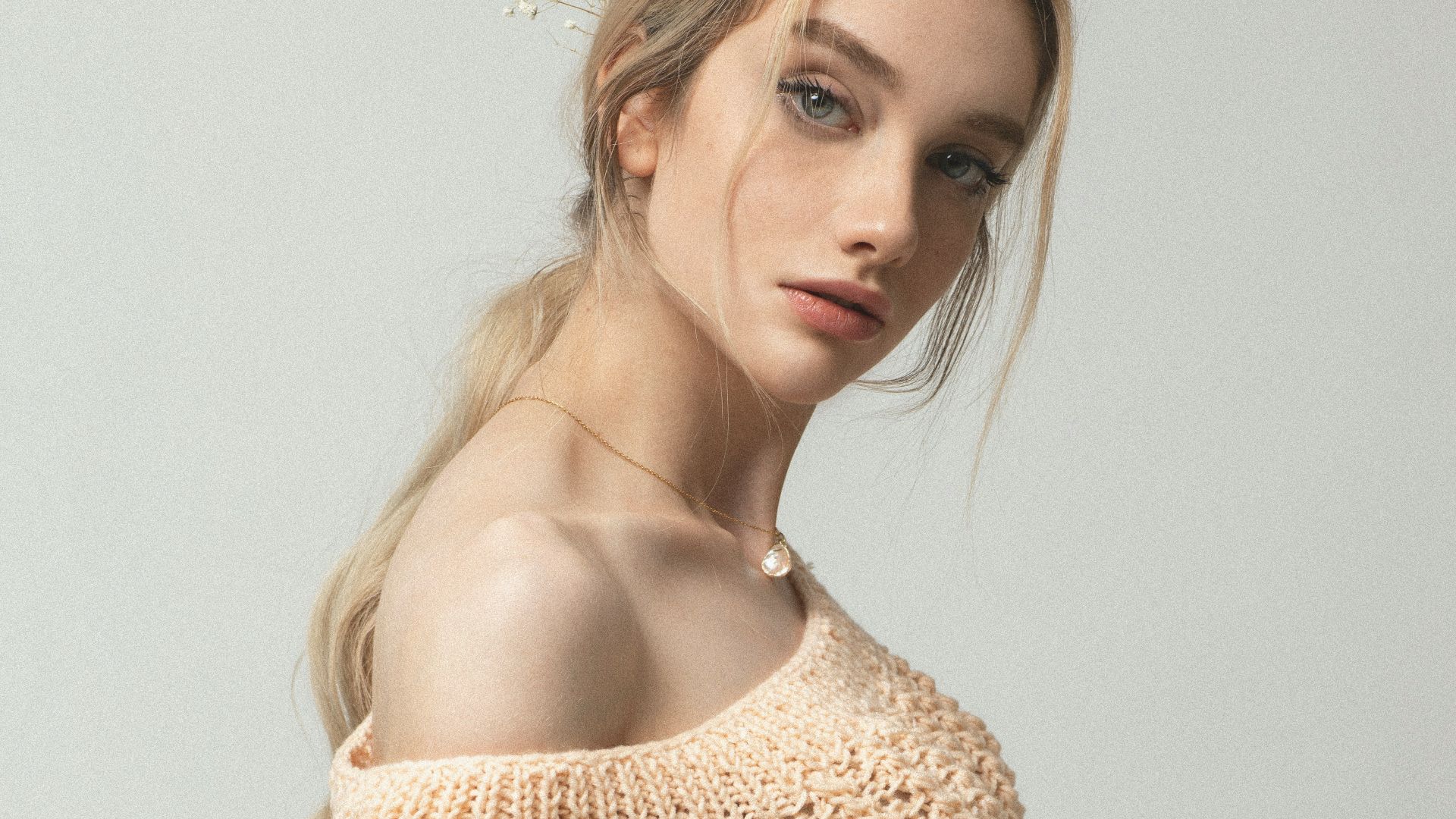 woman in beige knit off shoulder top