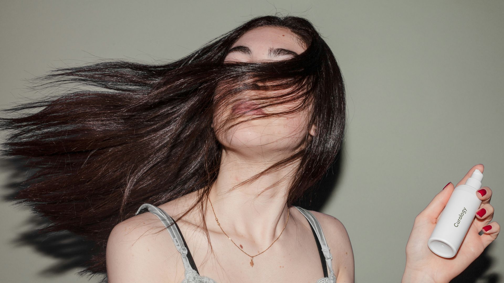 woman holding spray bottle