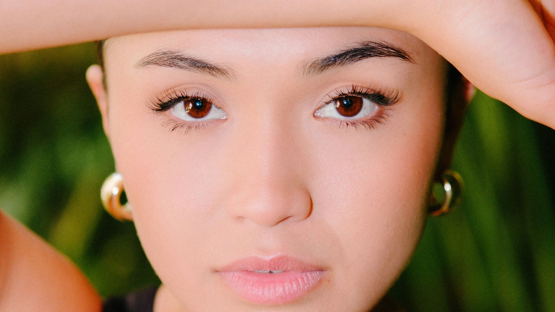 a woman is posing for a picture with her hand on her head