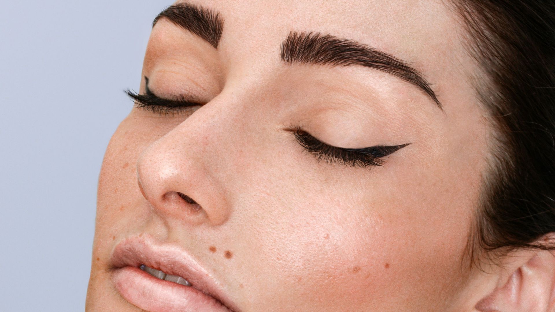 a woman with freckles on her face and neck