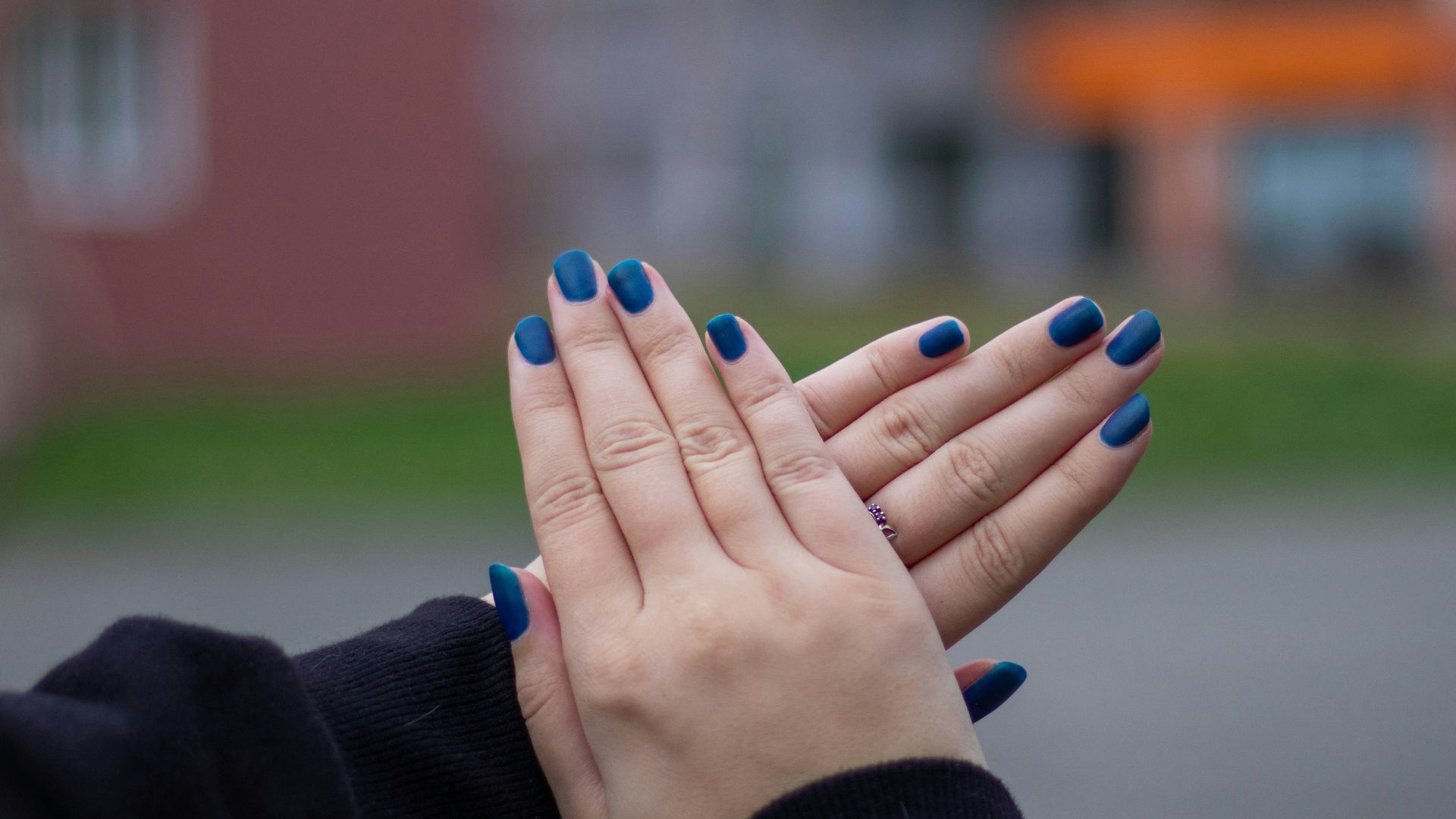 person with blue manicure and blue manicure