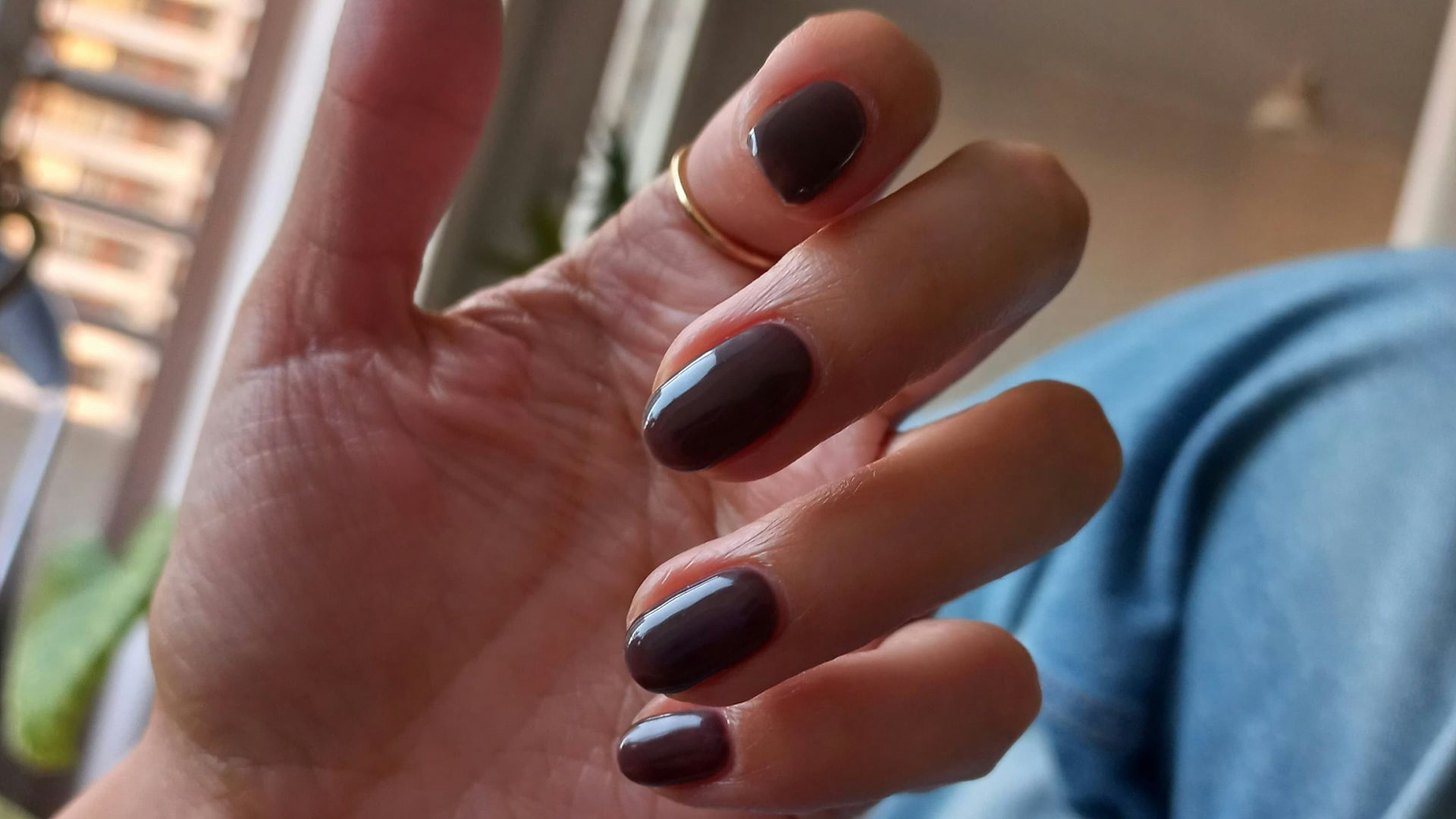 Hand with painted nails and a ring.