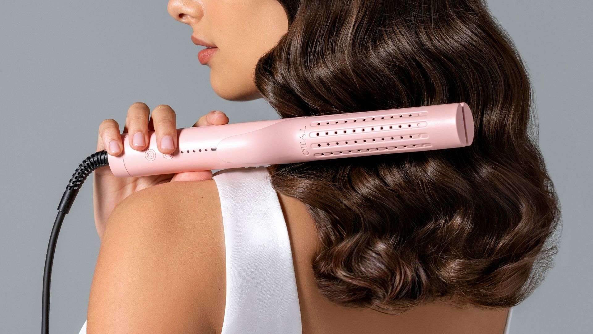 a woman using a hair dryer on her back