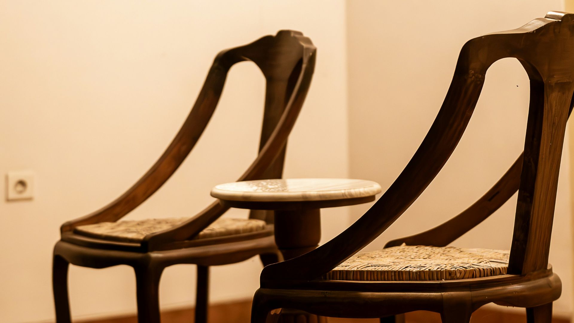 A couple of wooden chairs sitting next to each other