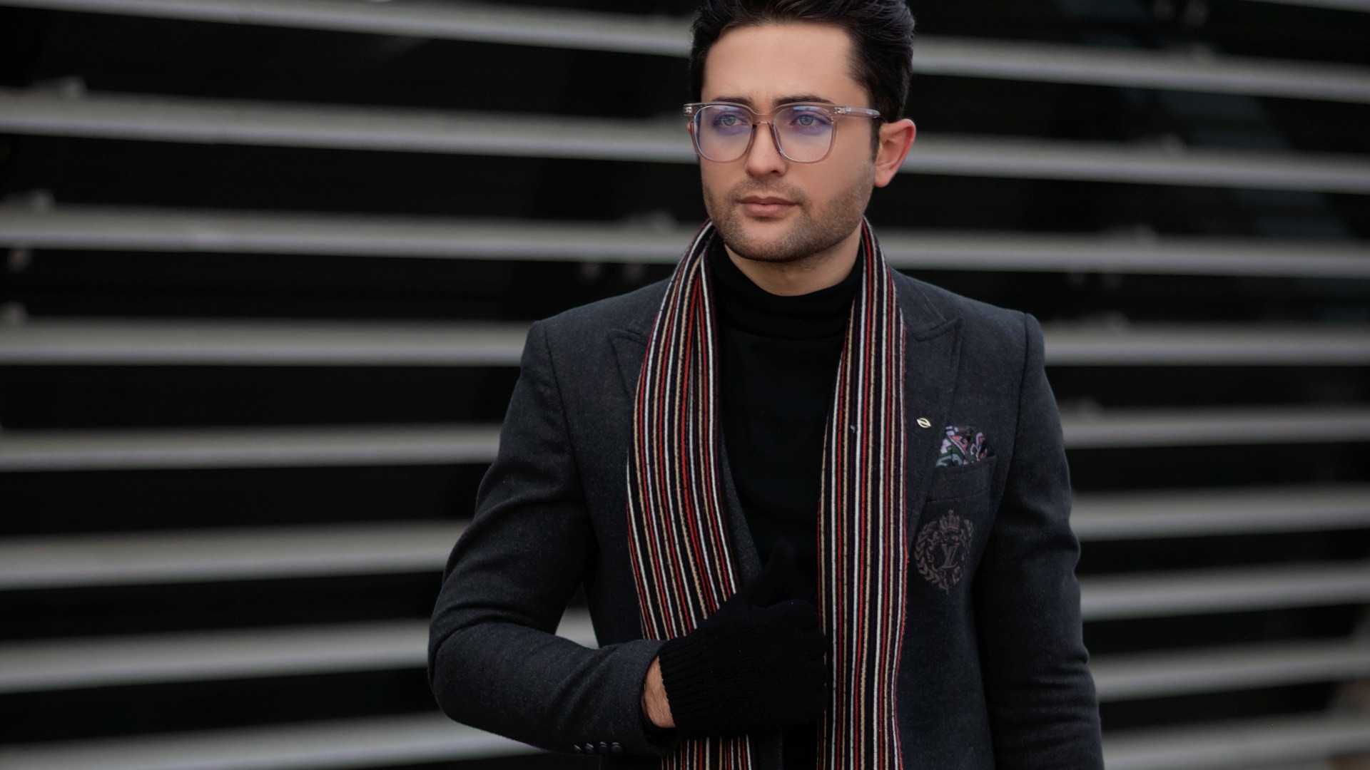 a man walking down a street wearing a scarf