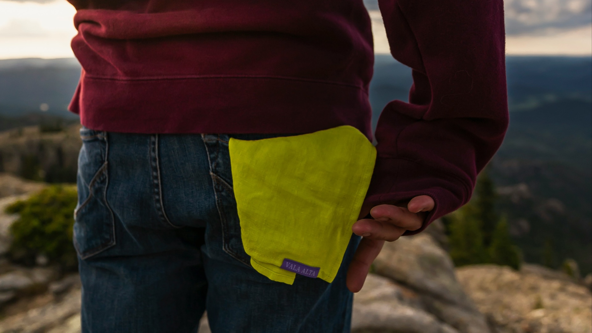 a man standing on top of a mountain with his back to the camera