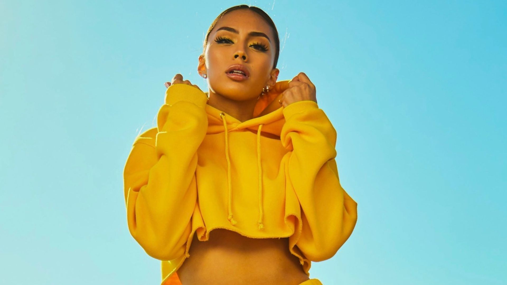 woman in yellow tracksuit standing on basketball court side