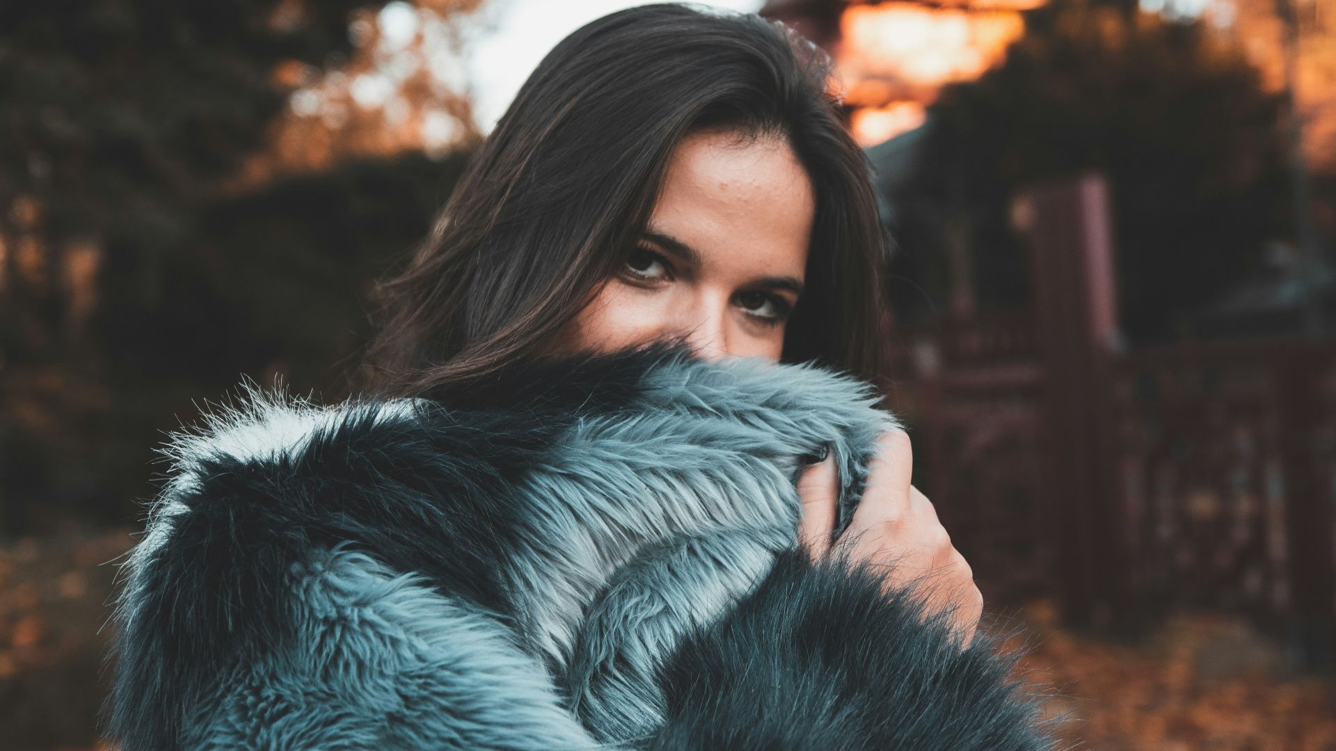 woman in gray and black fur coat standing