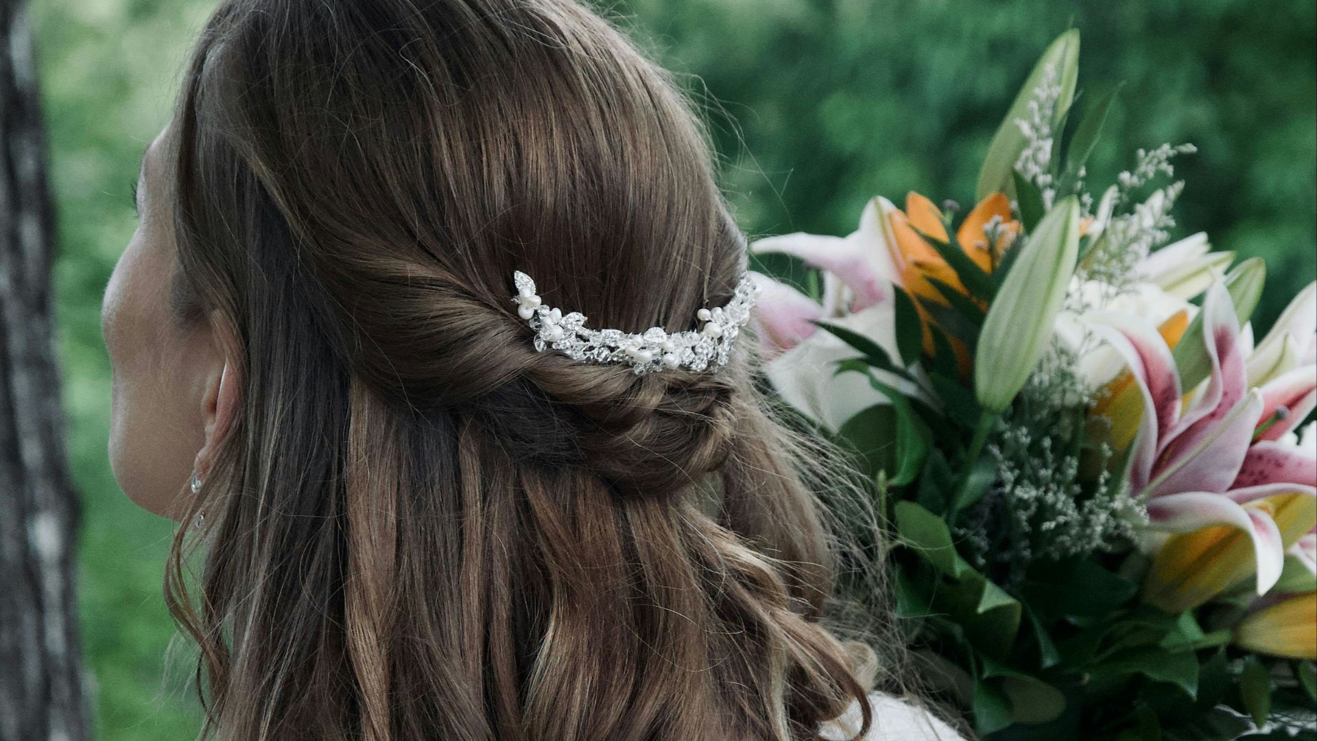Bride with elegant hairstyle holding a floral bouquet