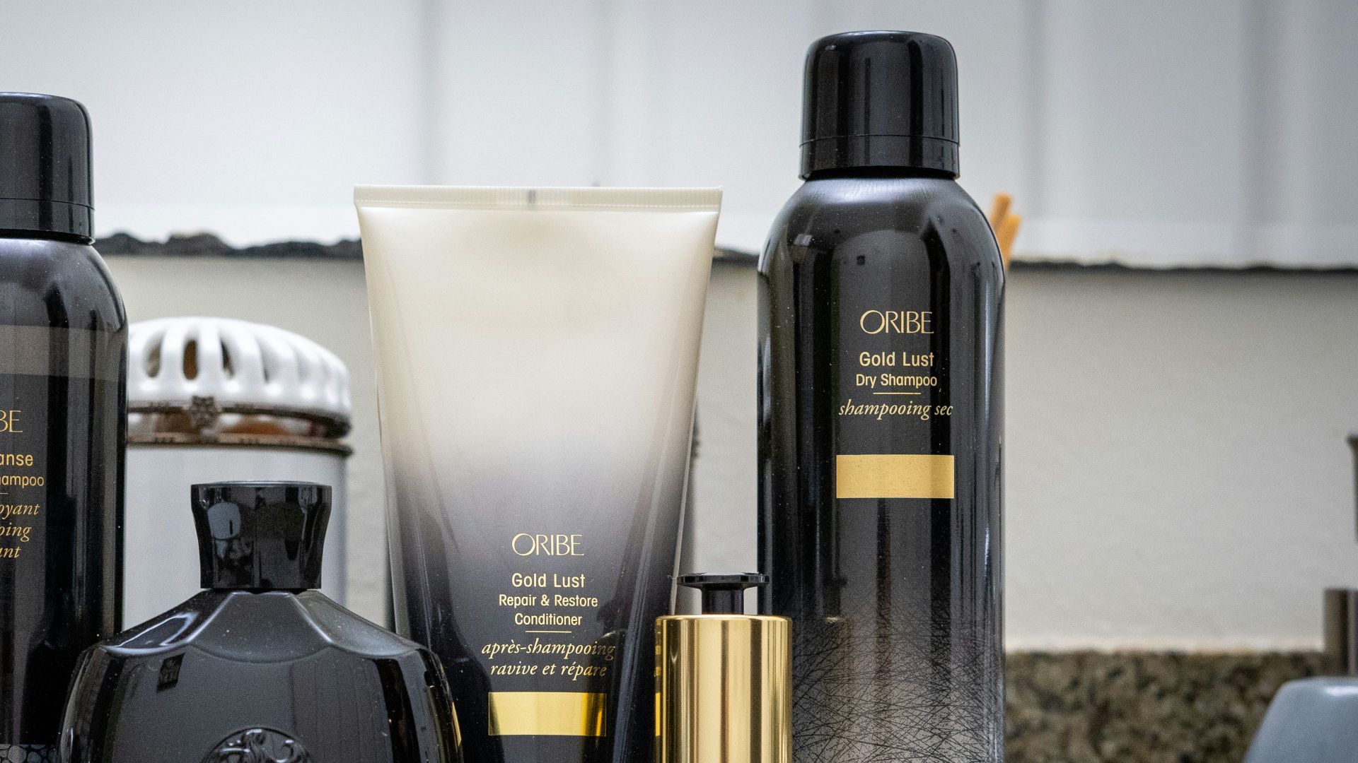 black and white spray bottle beside clear drinking glass