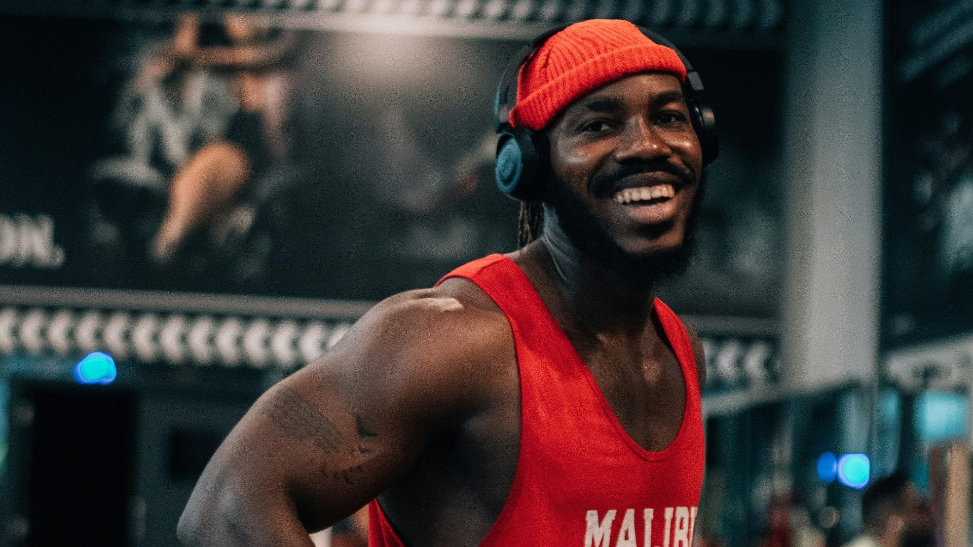 a man wearing a red shirt and headphones