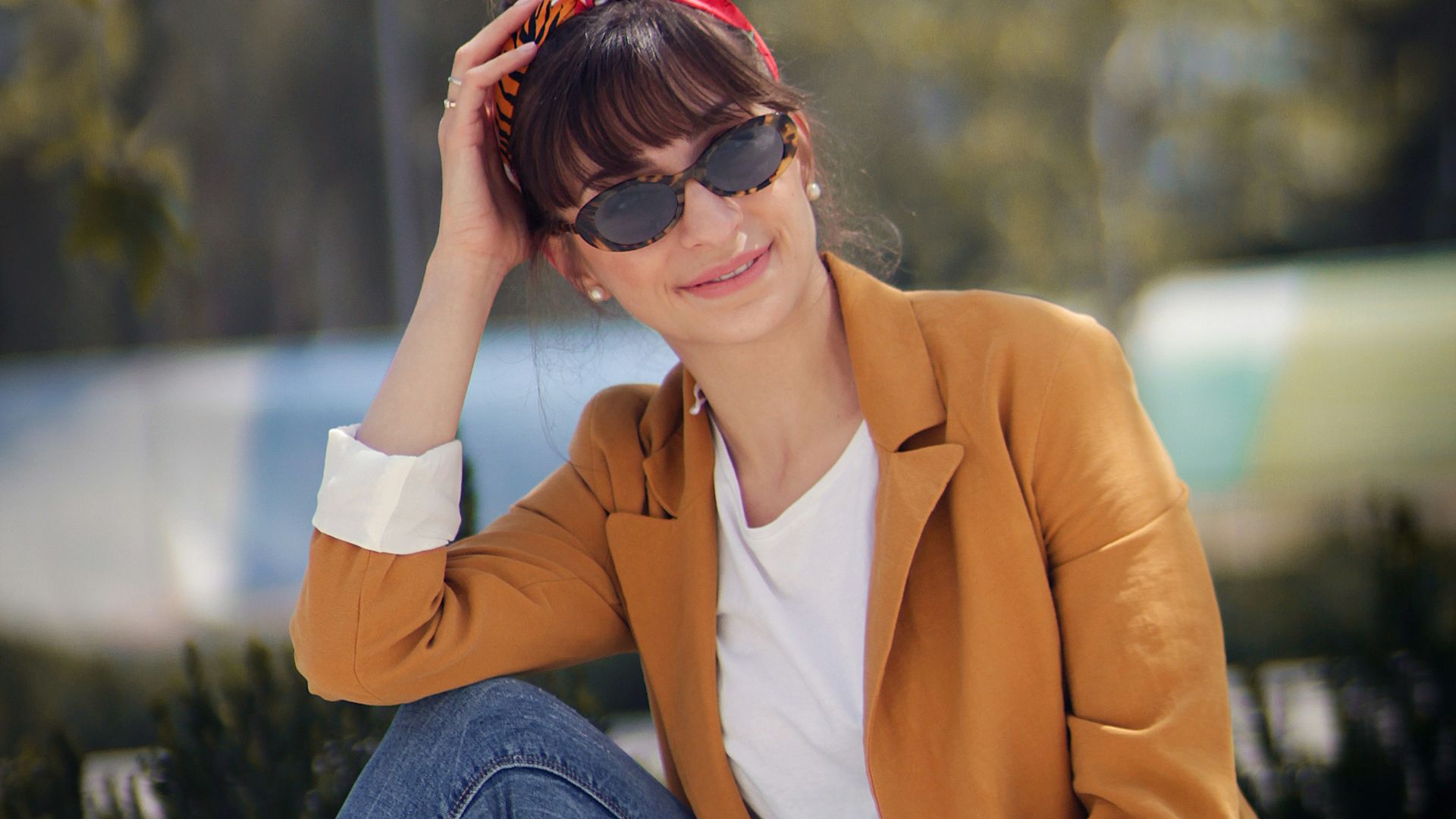 woman sitting on concrete bench near tree