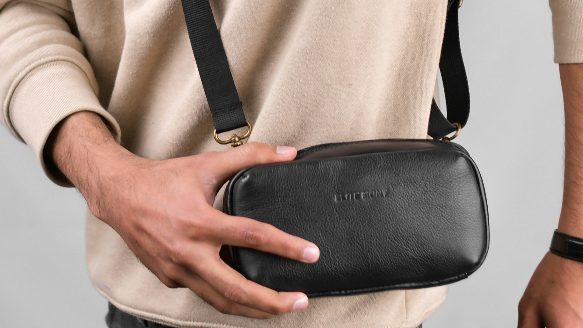 a man holding a black case in his left hand