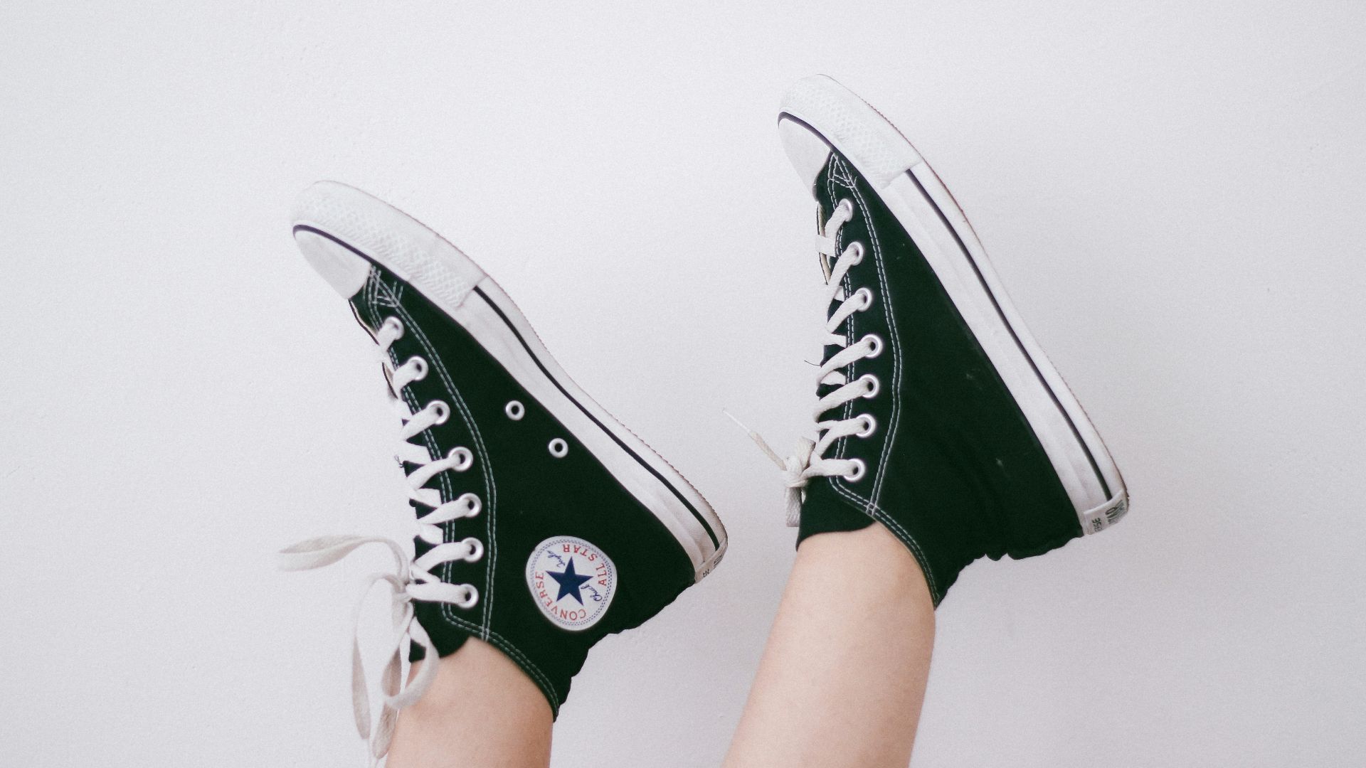 black and black and white Converse All Star high-top sneakers