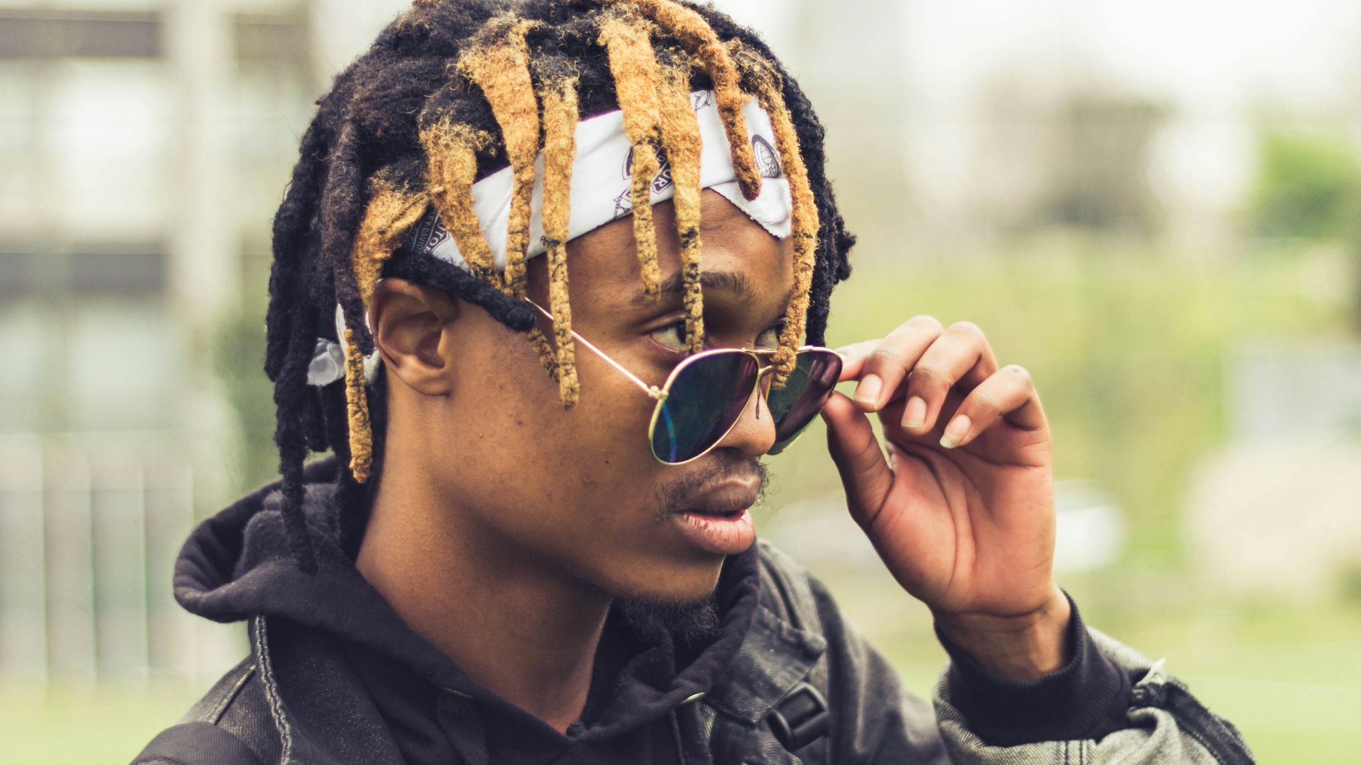 man in black leather jacket wearing black sunglasses