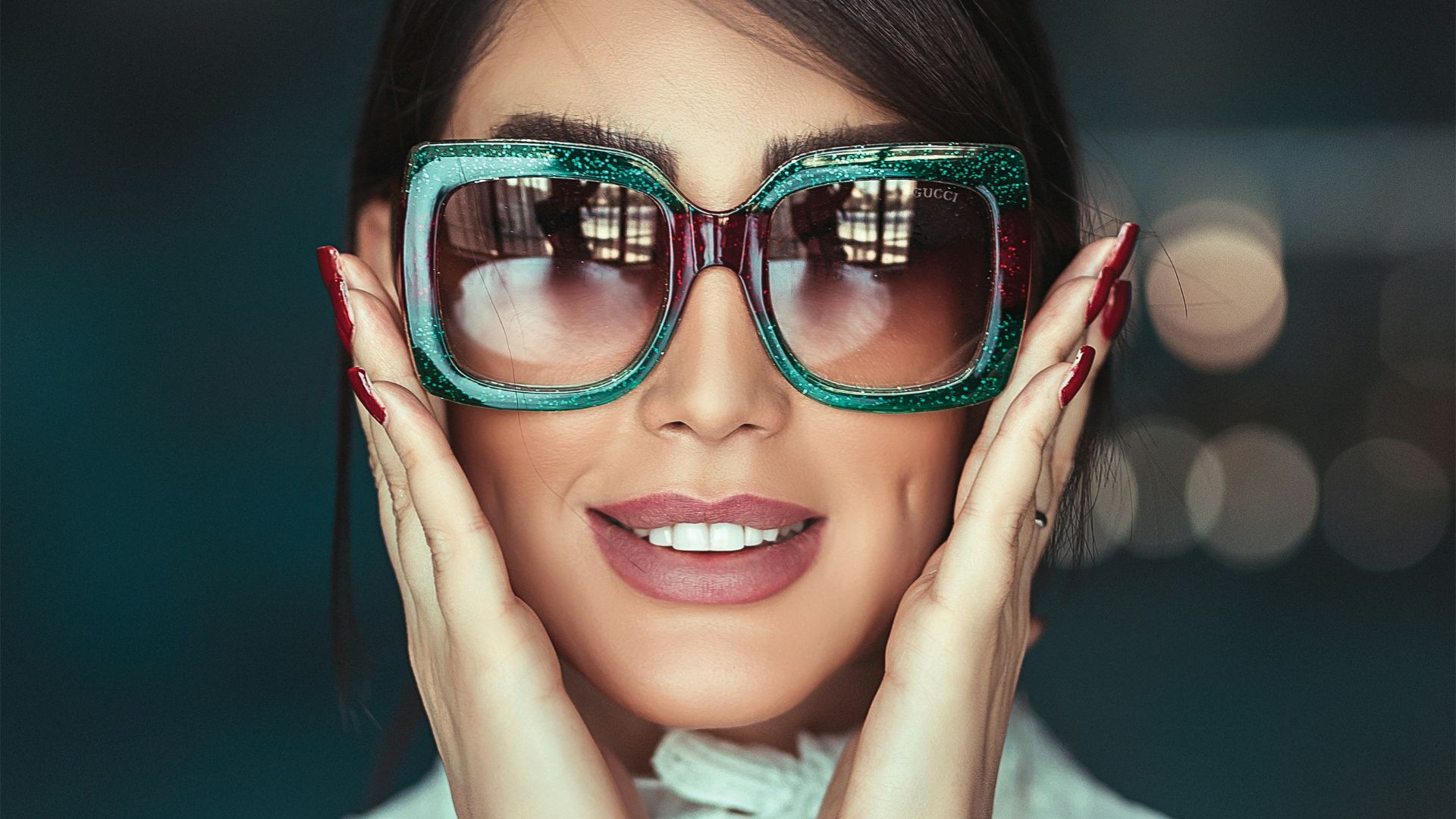 woman wearing green framed sunglasses