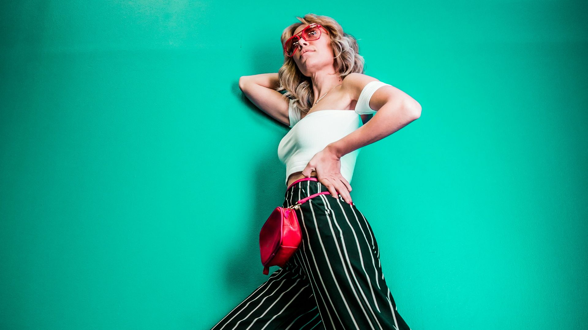 posing woman in white sleeveless top