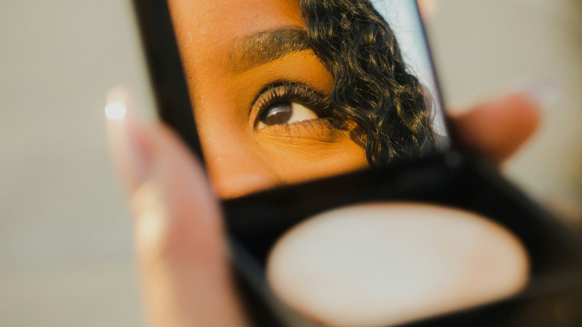 a woman holding a compact compact compact compact compact compact compact compact compact compact compact compact