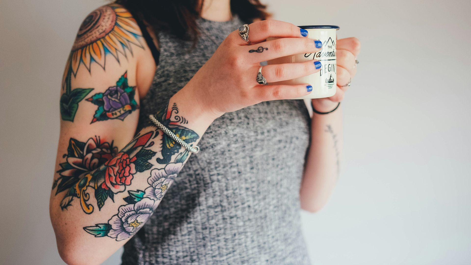 woman holding white ceramic mug